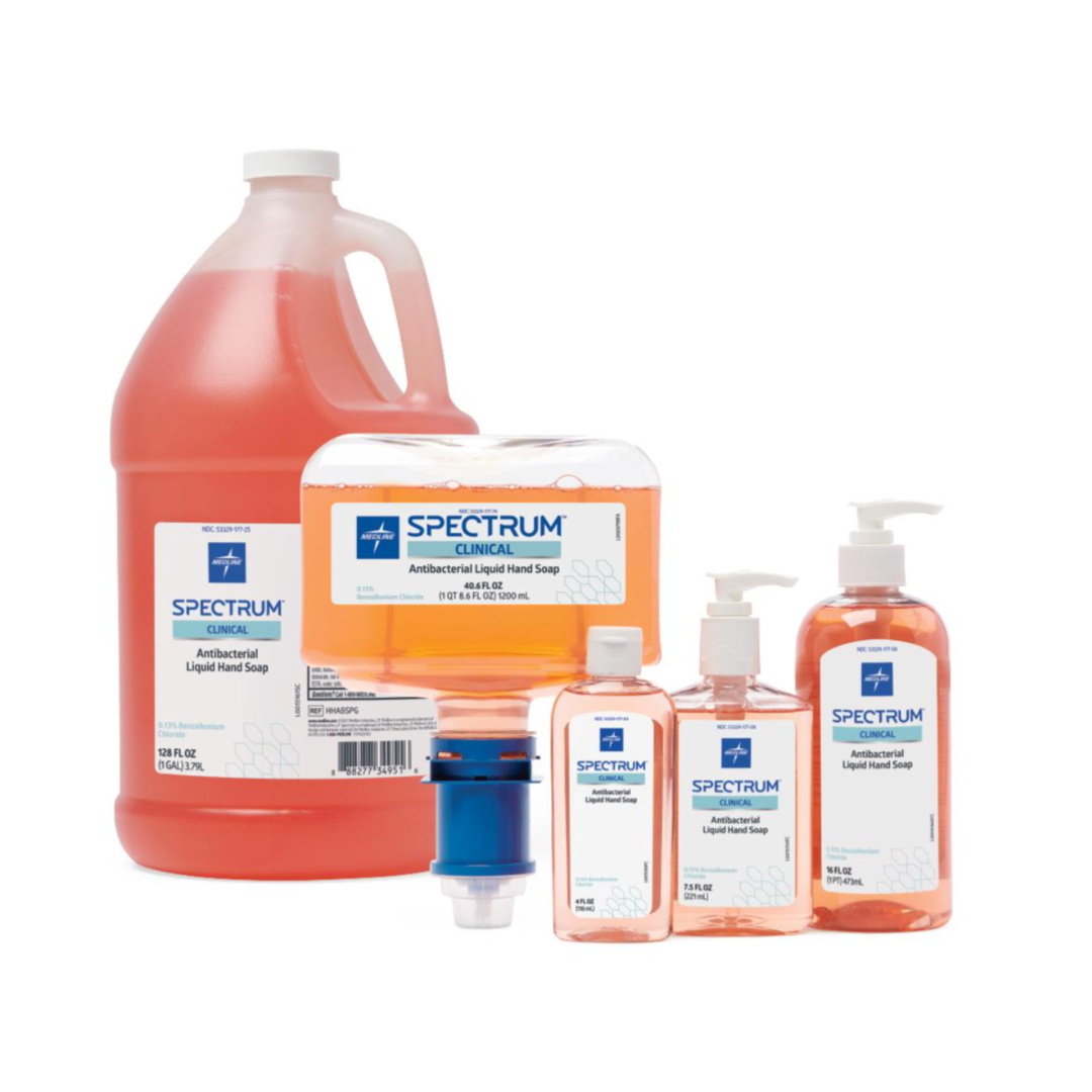 Five bottles of Medline Spectrum Antibacterial Liquid Hand Soap in multiple sizes—featuring a large jug, wall-mounted dispenser, and three pump bottles—each contains bright orange antibacterial soap.